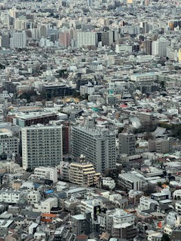 Aerial view showcasing the dense urban landscape and high-rise buildings in Tokyo, Japan.