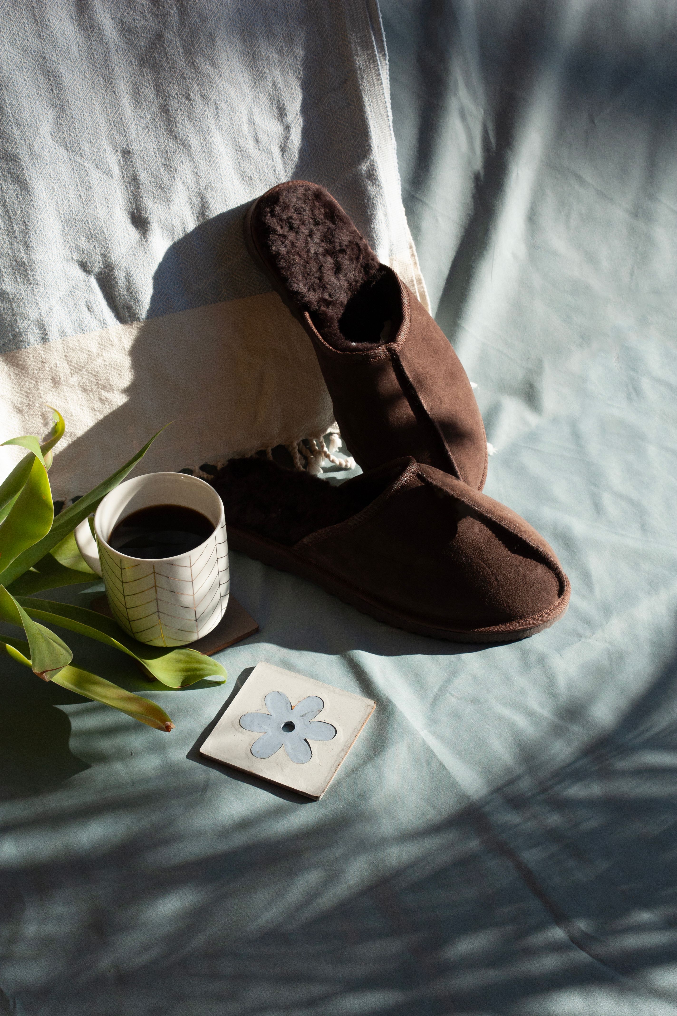 Cozy Morning Setup with Coffee and Brown Slippers · Free Stock Photo