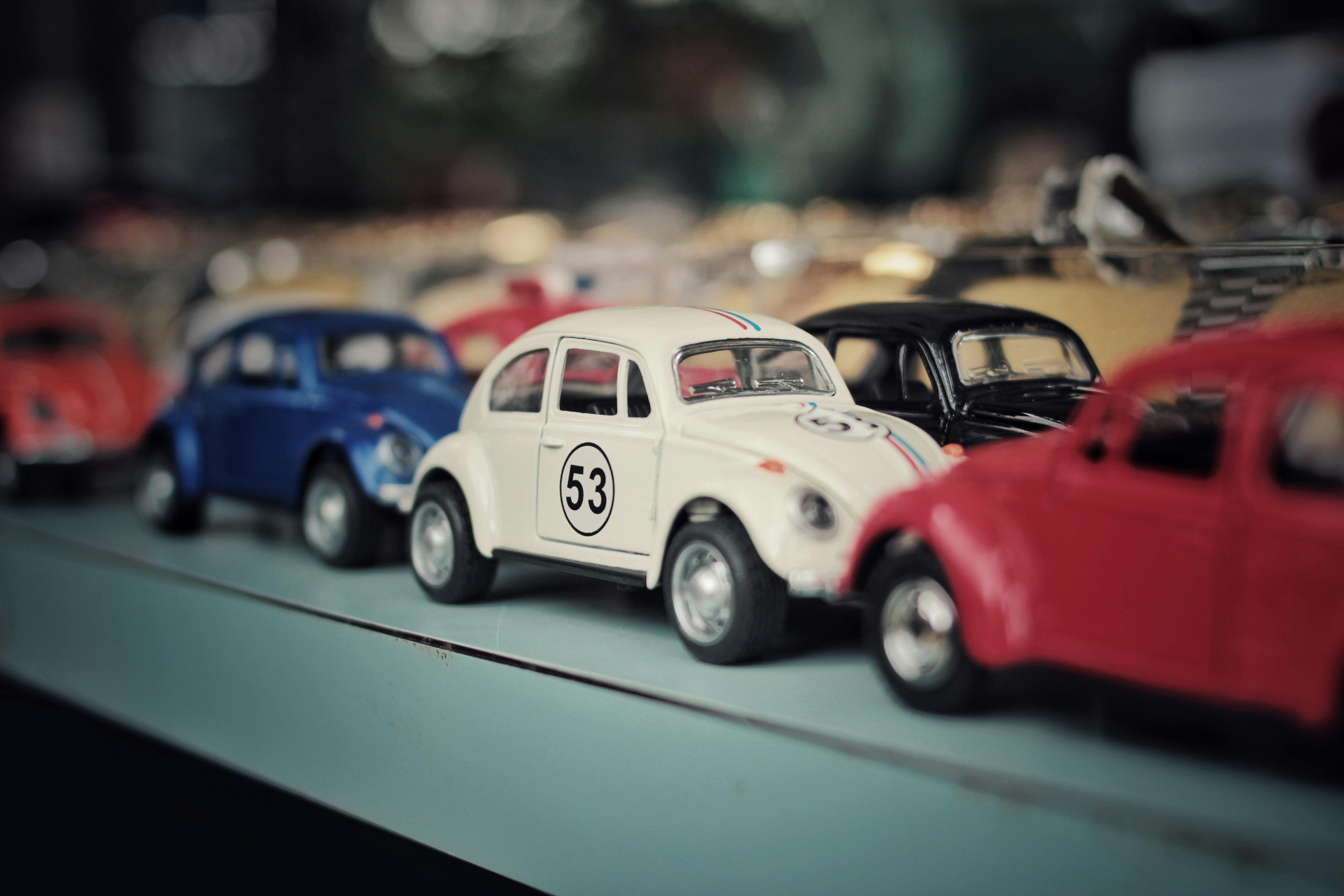 A close-up of colorful vintage toy cars on a display shelf, showcasing a nostalgic collection.