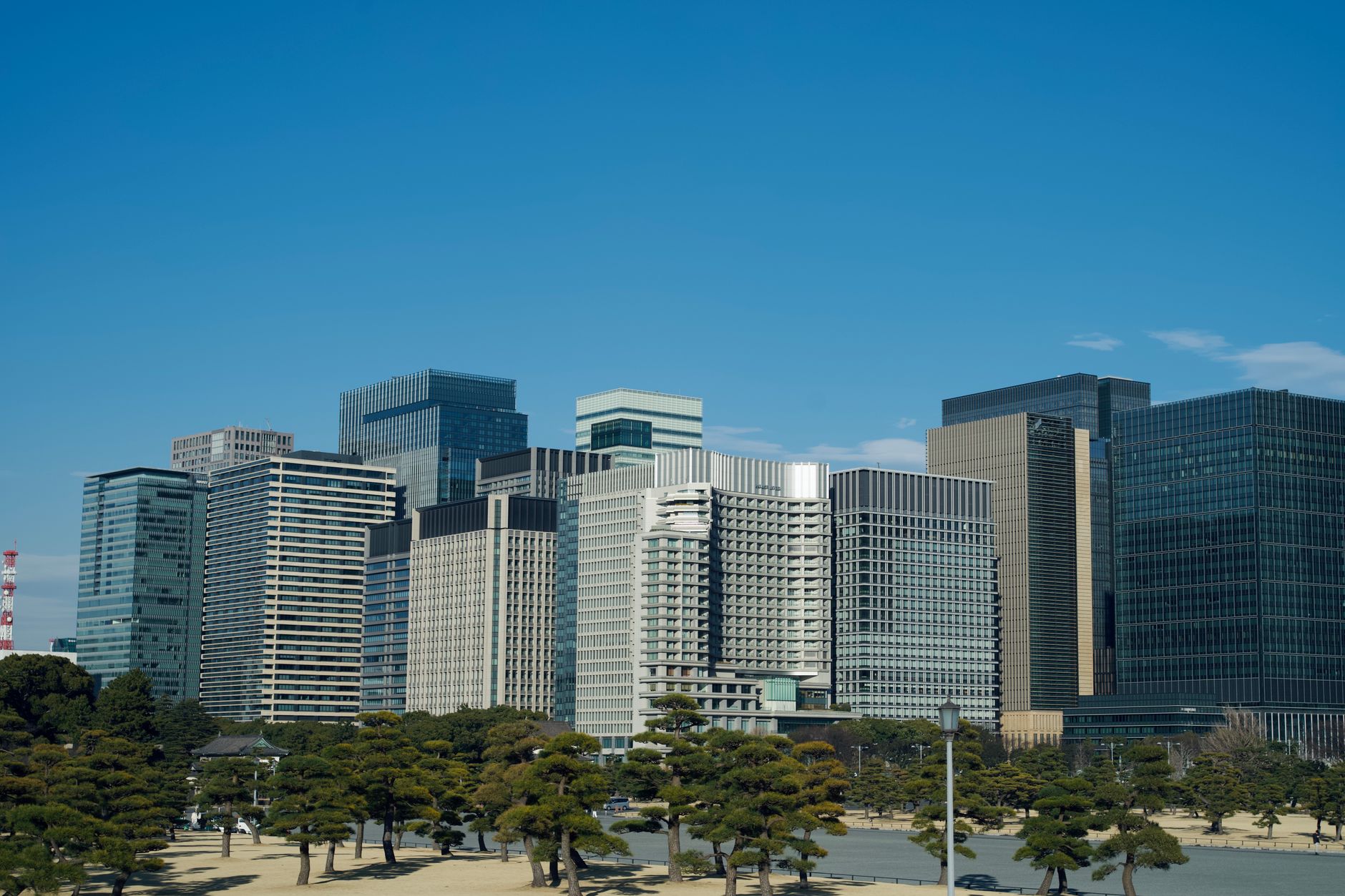 City skyline featuring modern skyscrapers under a clear blue sky.