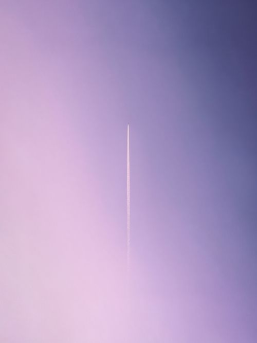 Free Airplane contrail against a pink and purple pastel sky in Amman, Jordan. Stock Photo