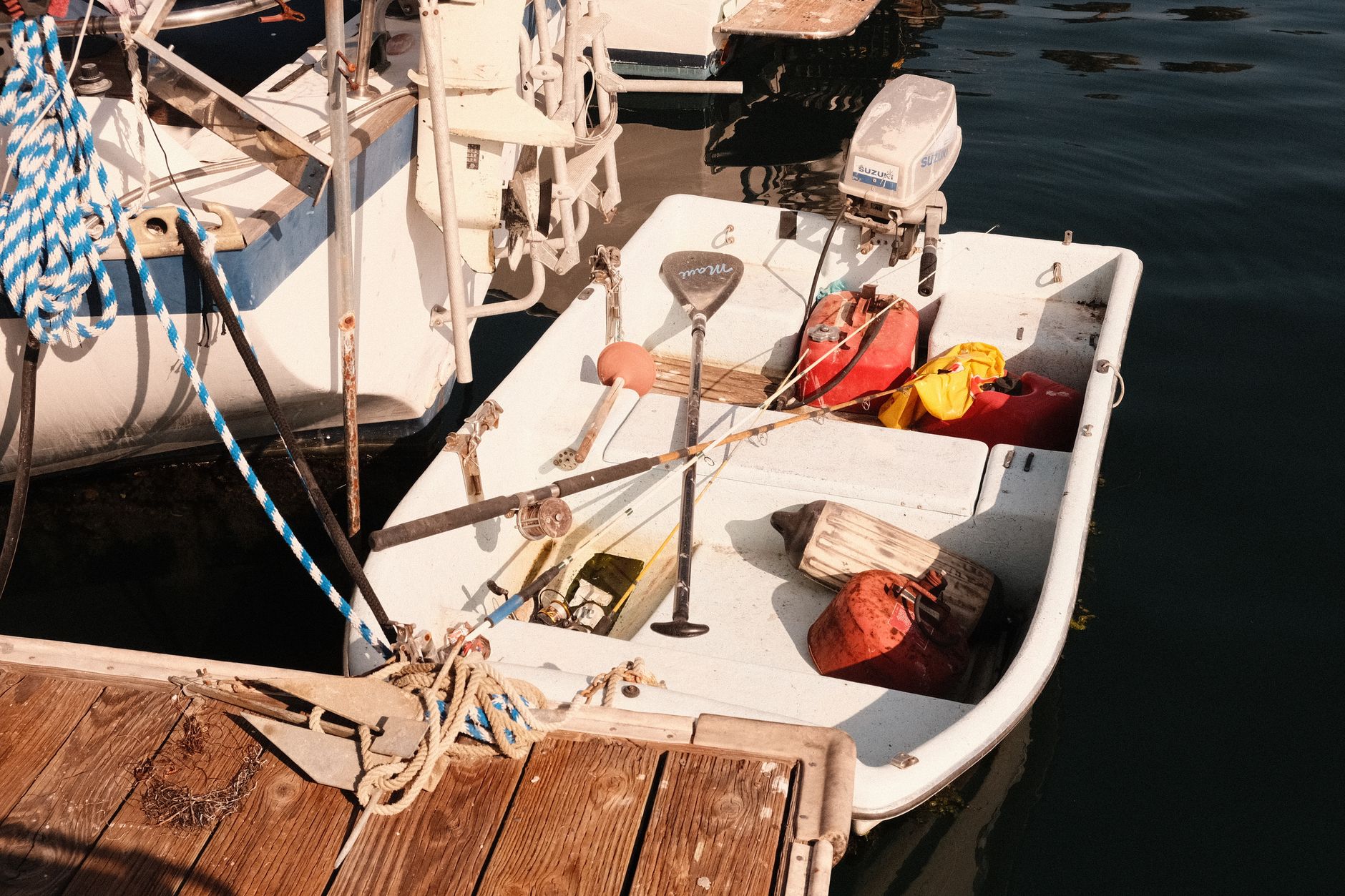 Trailer boat parked out of the water with the outboard tilted up for an off-season check