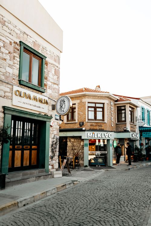 Free Cobblestone street with shops and hotel in Urla, İzmir during golden hour. Stock Photo
