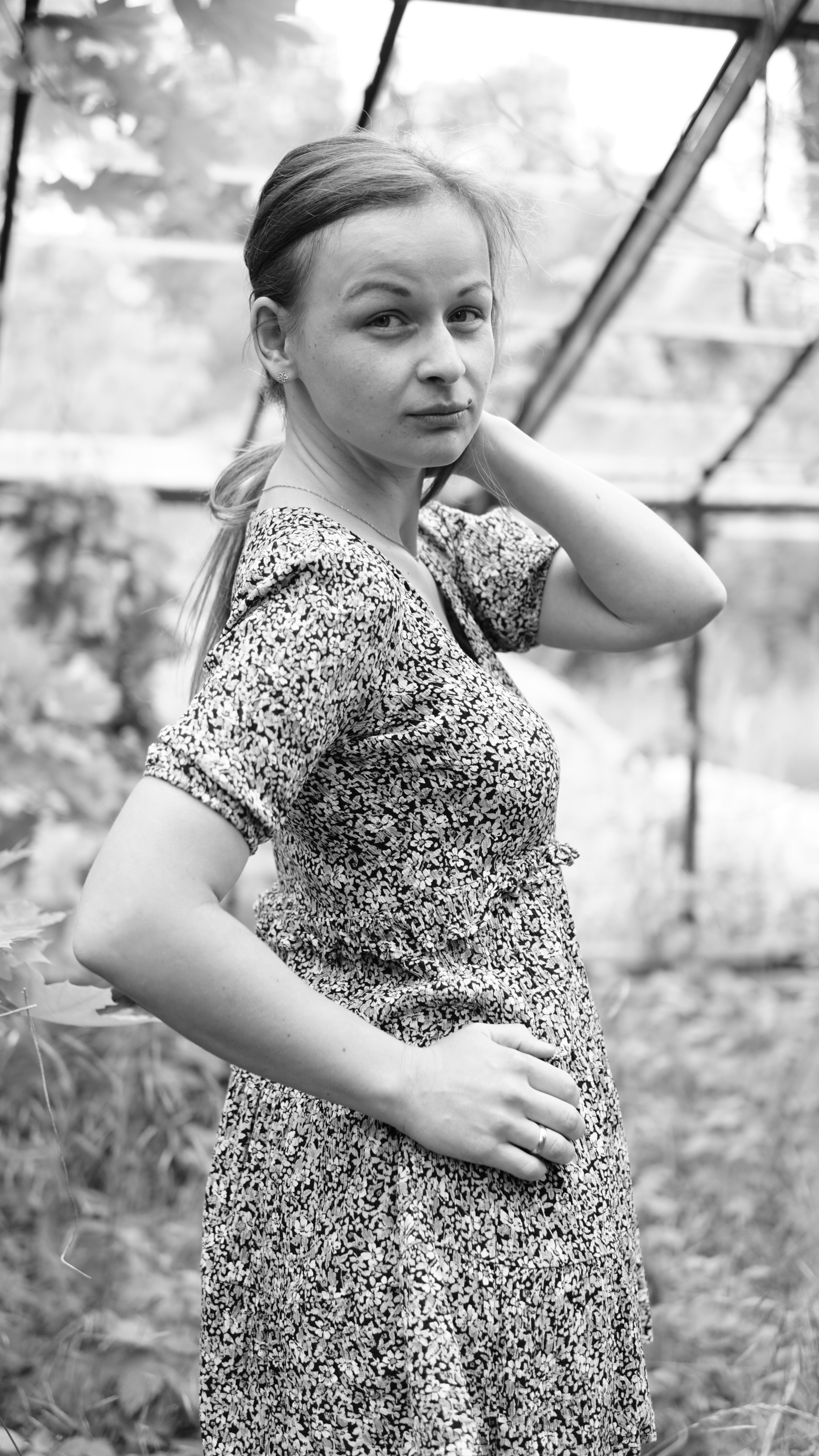 Woman in Floral Dress Posing Outdoors · Free Stock Photo