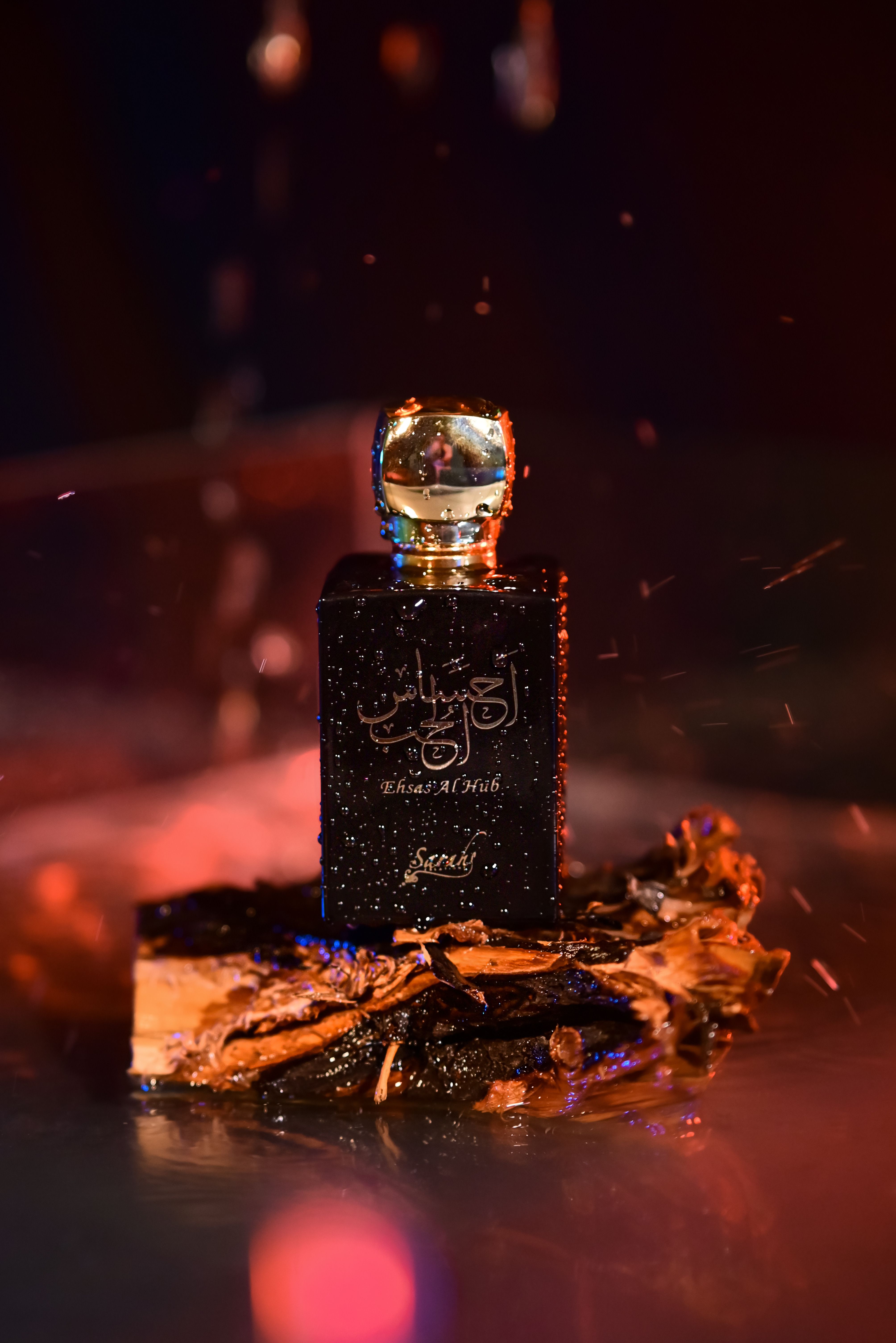 Luxurious perfume bottle with wood base in a dramatic, warm setting.