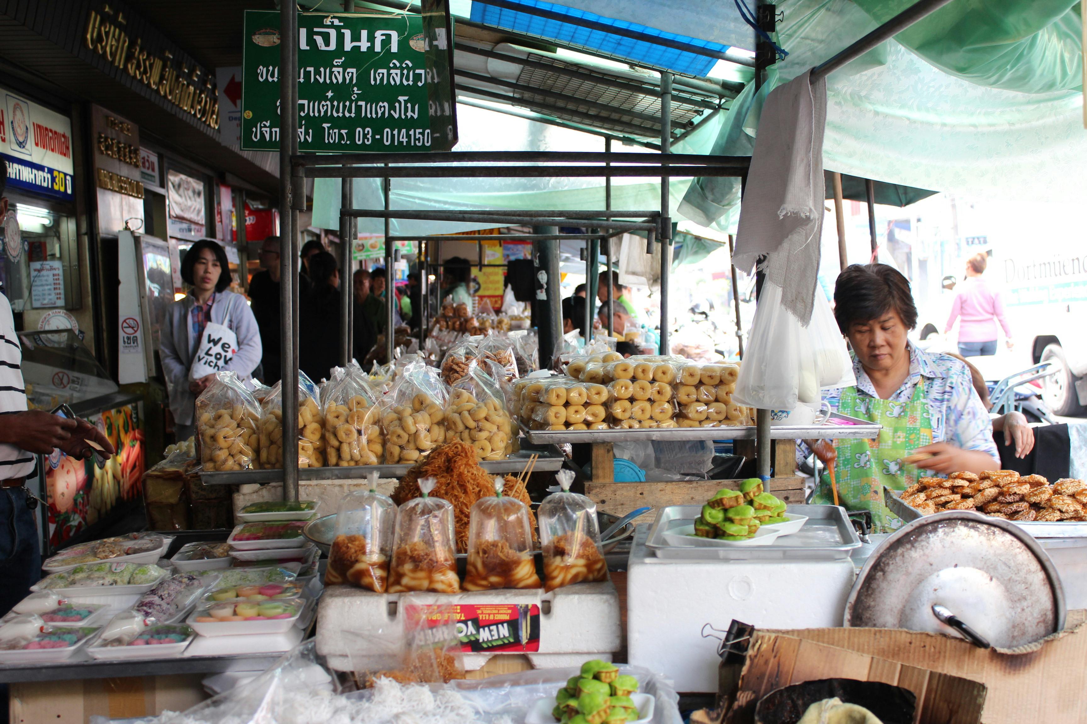 Vibrant bustling Bangkok street food market with vendors and colorful stalls