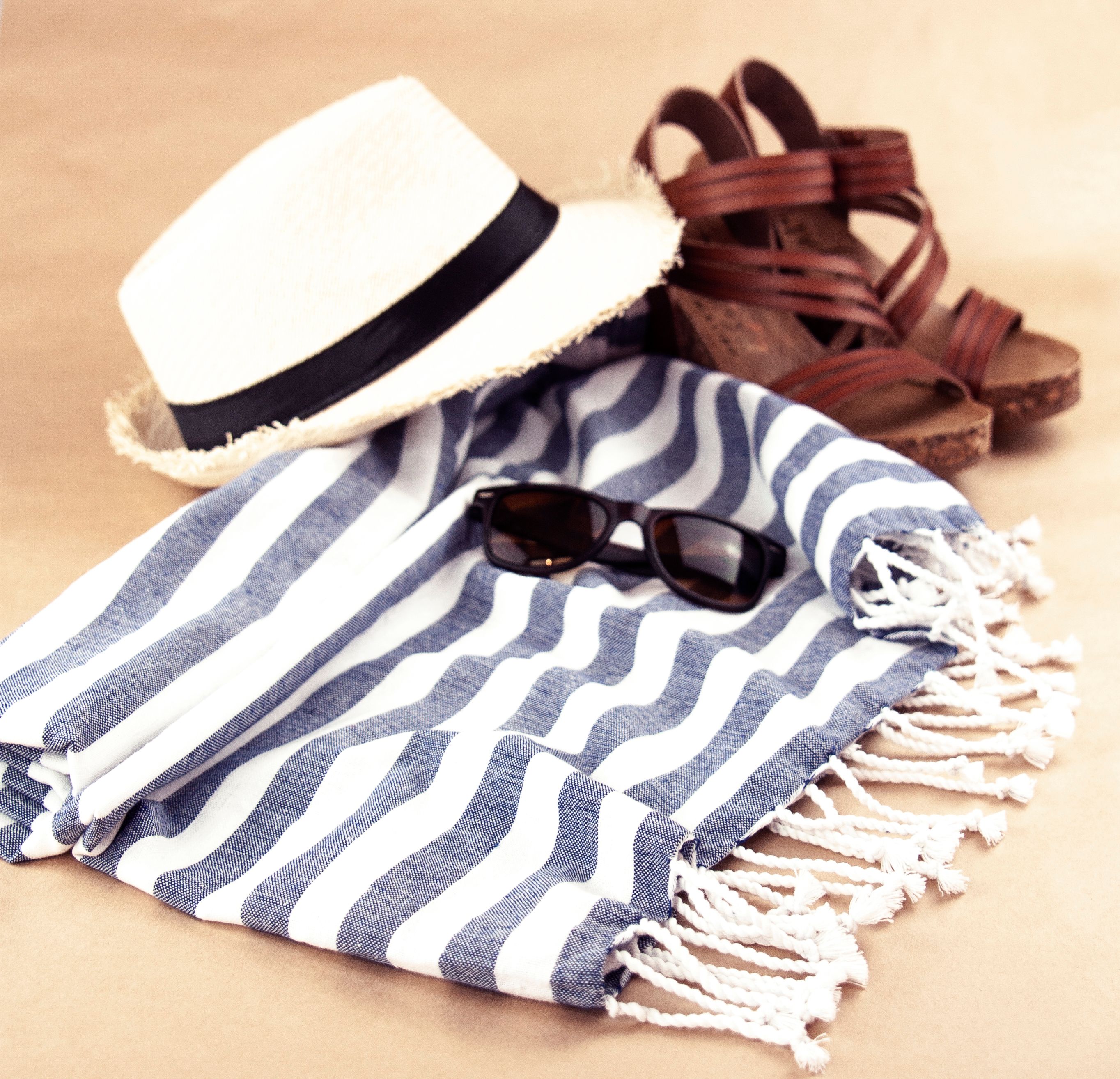 Stylish Beach Accessories on a Striped Towel · Free Stock Photo
