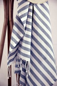 Slate stripe throw hung over a ladder — photo by Karen Laårk Boshoff on Pexels