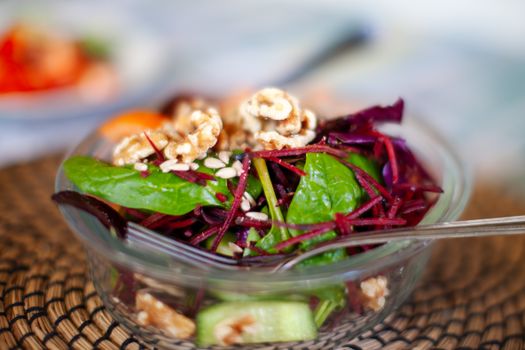 Vibrant beetroot and spinach salad with walnuts, perfect for a healthy meal.