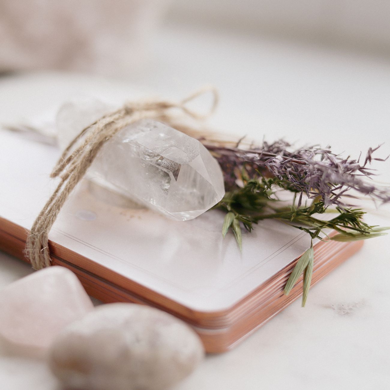 A serene composition of a quartz crystal, lavender, and spiritual cards for meditation.