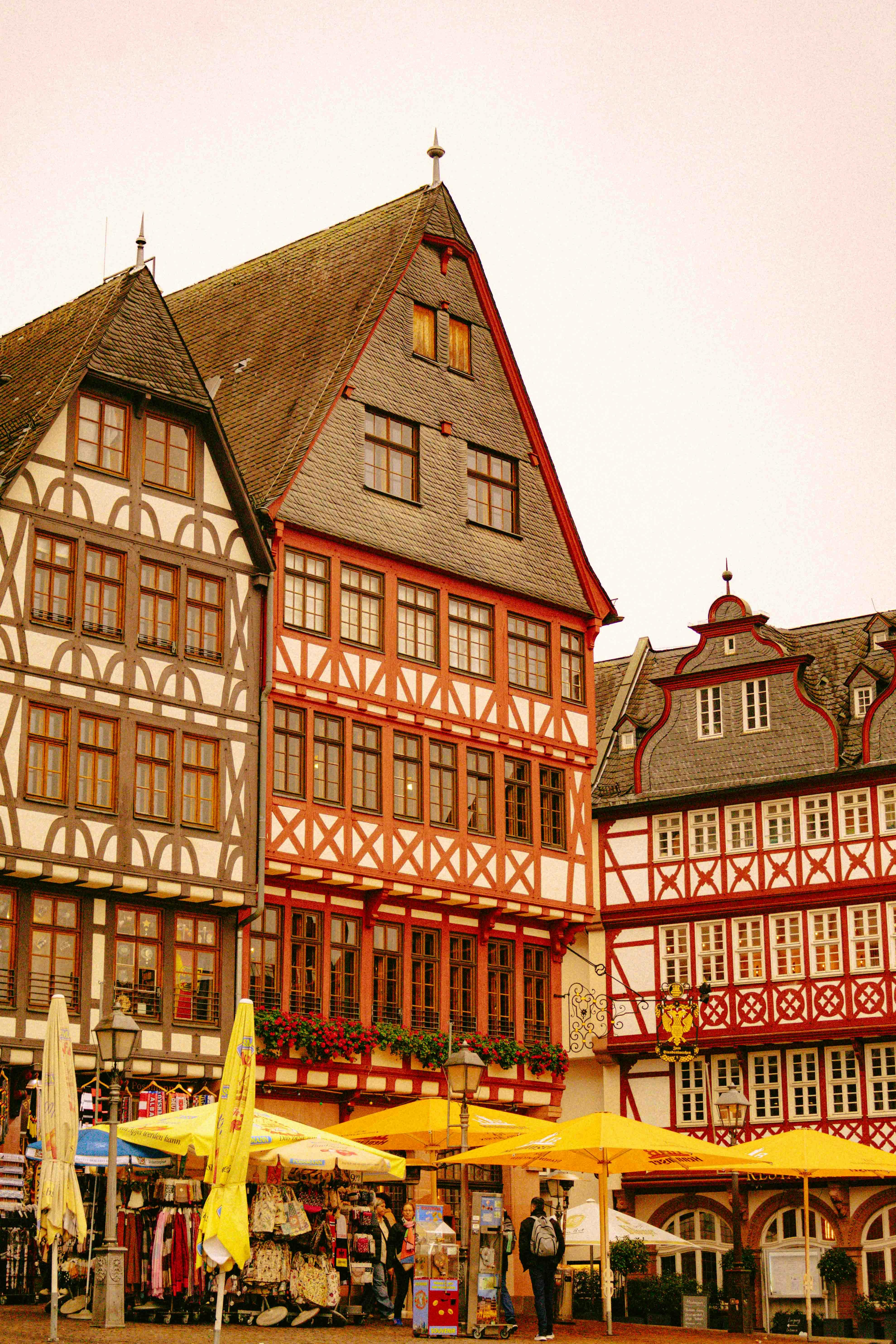Explore the iconic half-timbered buildings of a German market square under a golden sky.
