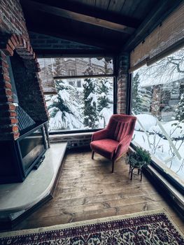 Warm interior featuring a fireplace and snowy outdoor view, perfect for winter relaxation.