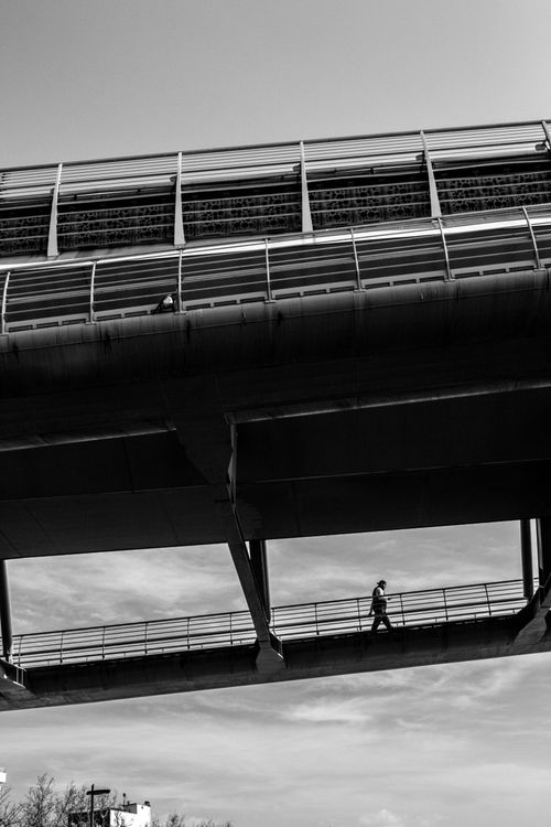 Free Black and white photo of a person walking on a bridge in İstanbul, illustrating urban architecture. Stock Photo