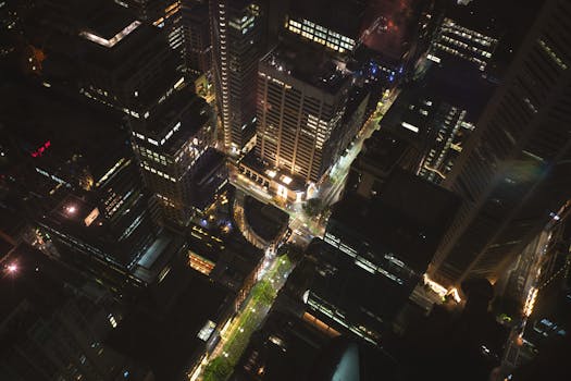 Stunning aerial view of Sydney's illuminated skyscrapers at night.