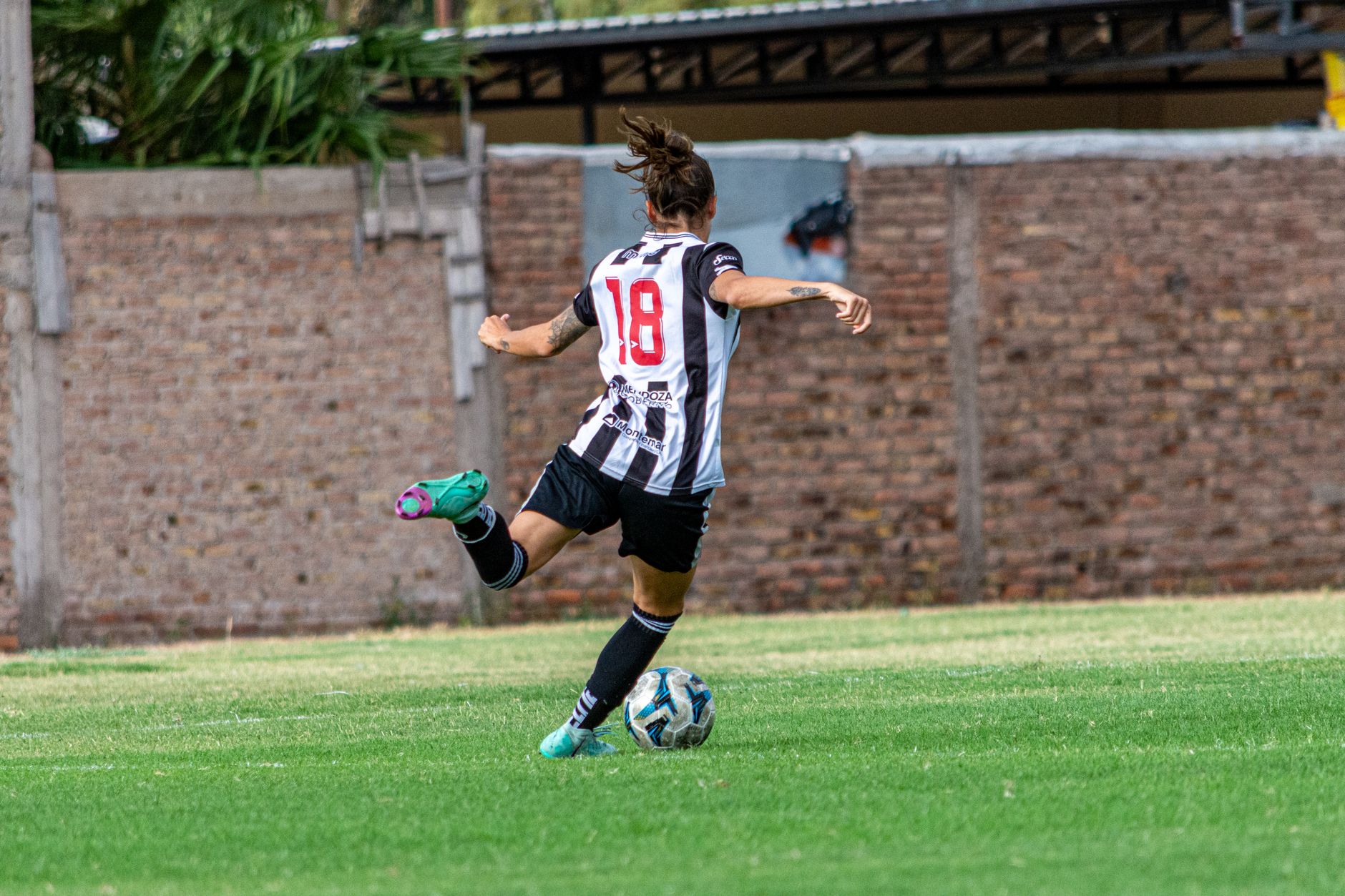 amateur footballer performing a controlled Copenhagen plank beside cones and resistance bands