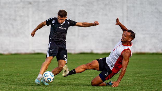 Intense soccer match featuring two players in action, showcasing athleticism and teamwork.