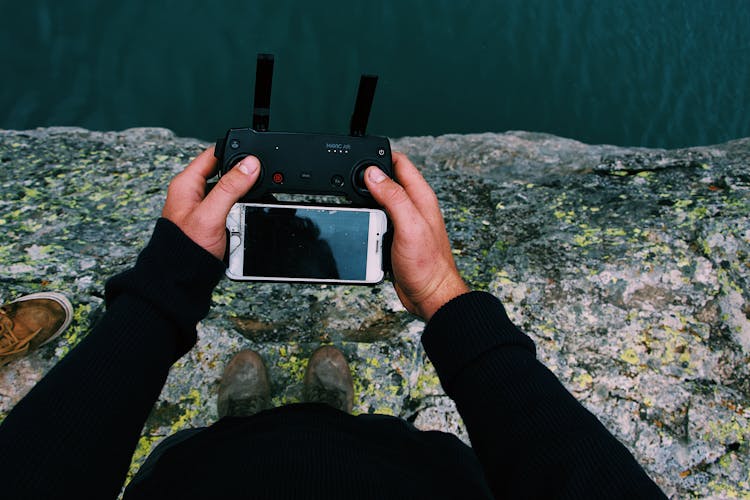 High Angle Photo Of Person Holding Remote Control