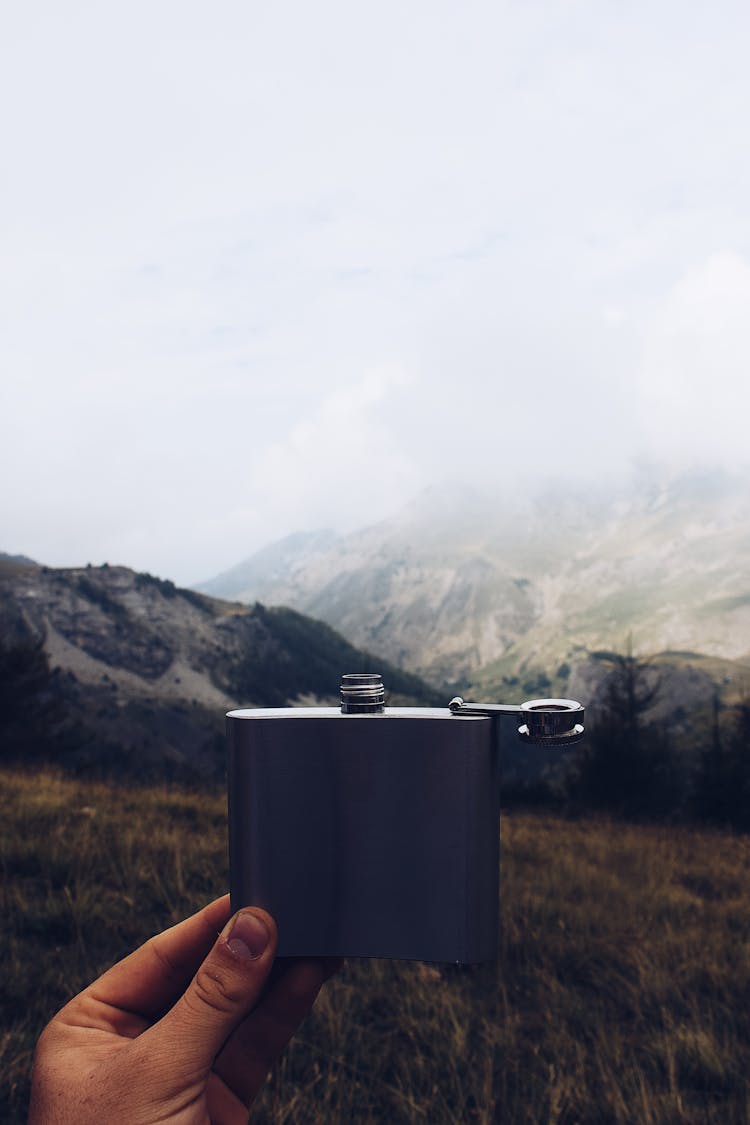 Person Holding Hip Flask