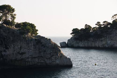 Free Beautiful view of rocky cliffs and calm sea under daylight, perfect for travel and nature lovers. Stock Photo
