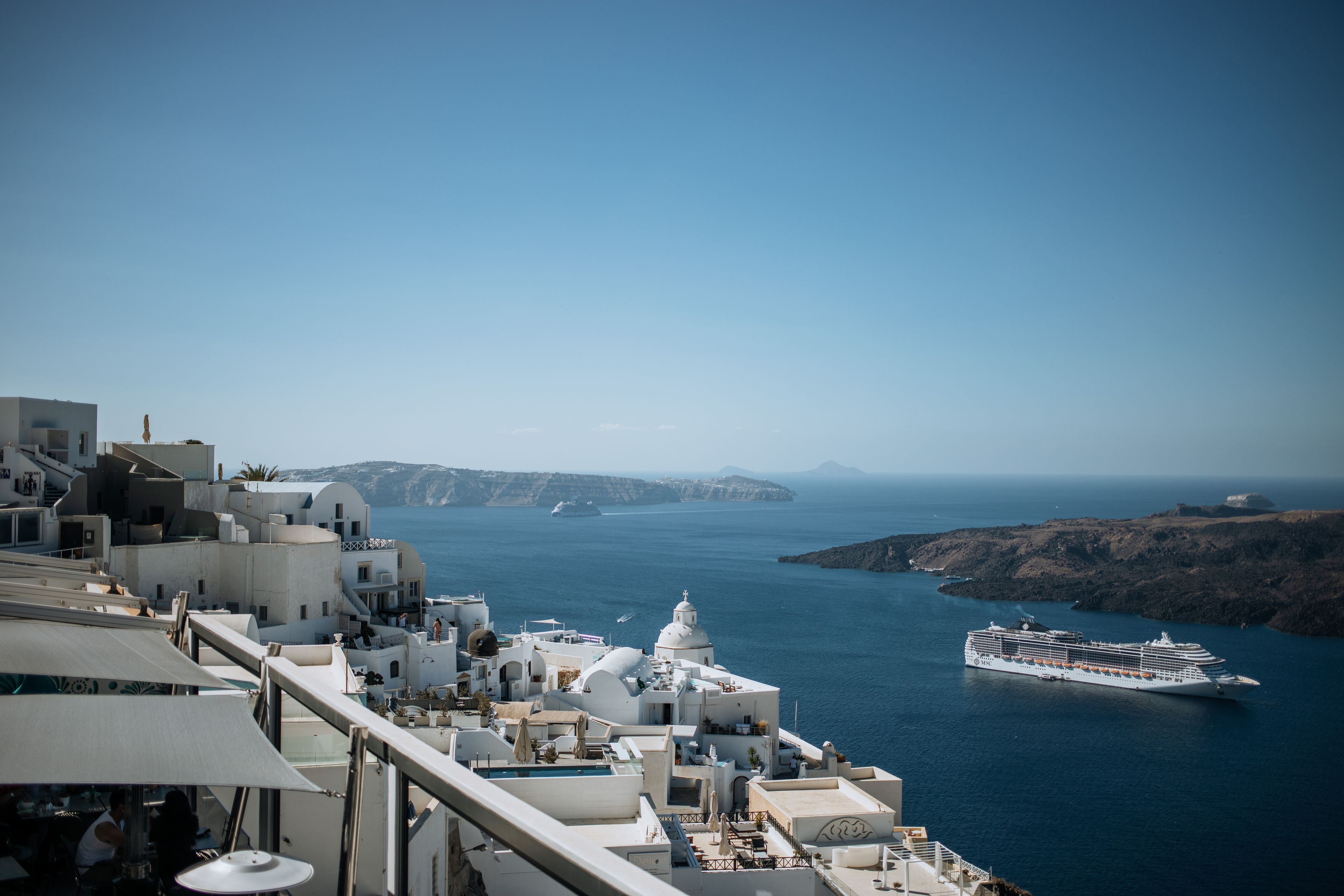 Luxury caldera-view suite with private plunge pool in Santorini at sunset