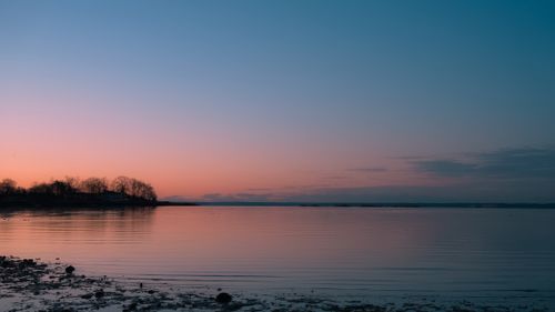 Free Tranquil pink sunrise over water at Cove Island Park, Stamford, Connecticut. Stock Photo