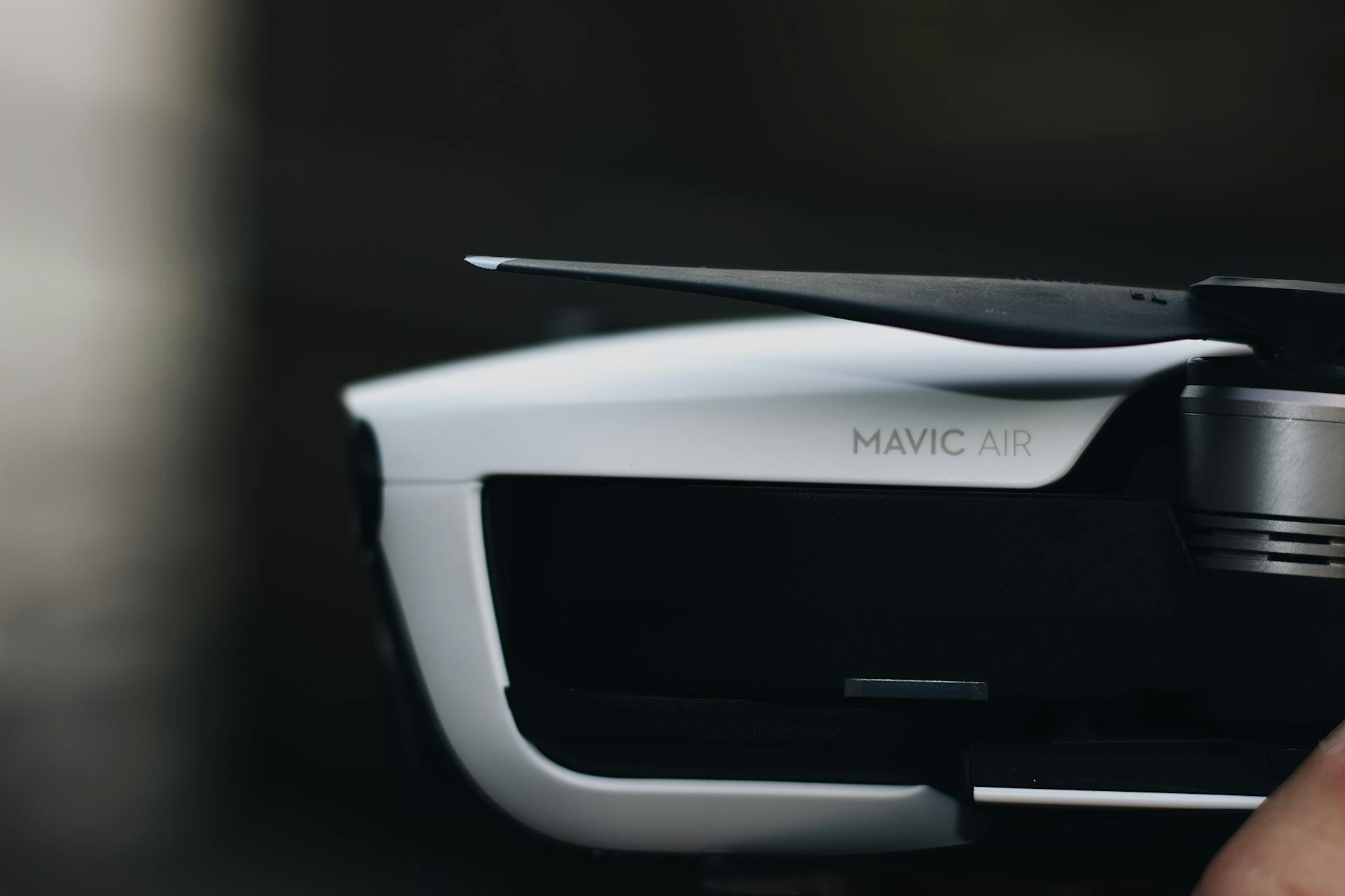 Detailed close-up of a DJI Mavic Air drone, highlighting the propeller and sleek design.