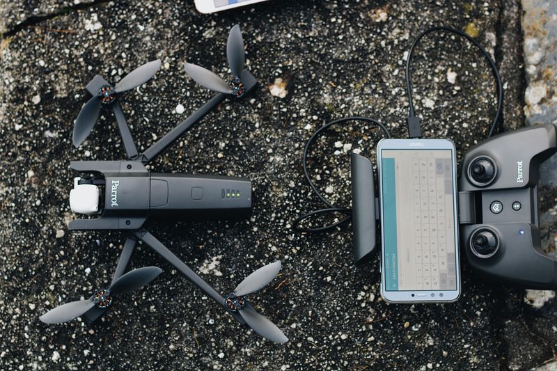 Rental drone and controller laid out before a student flight