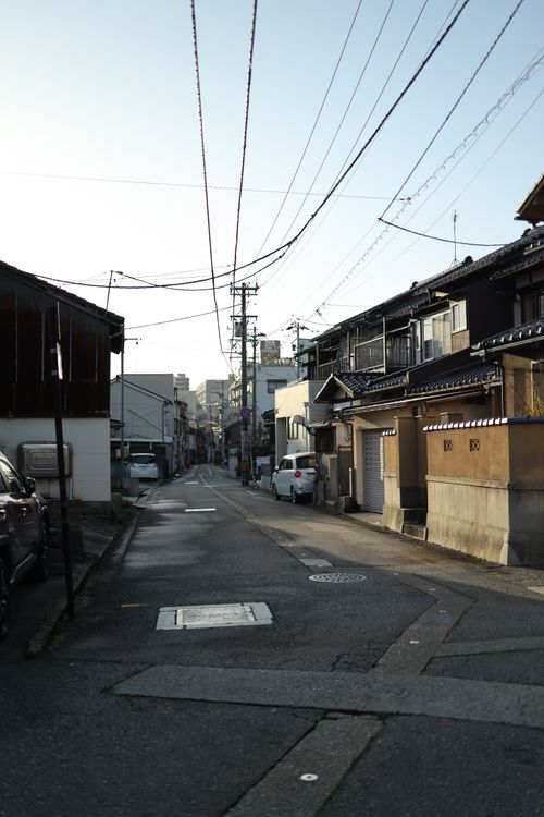 Free Tranquil urban street scene showcasing traditional houses under a clear sky. Stock Photo