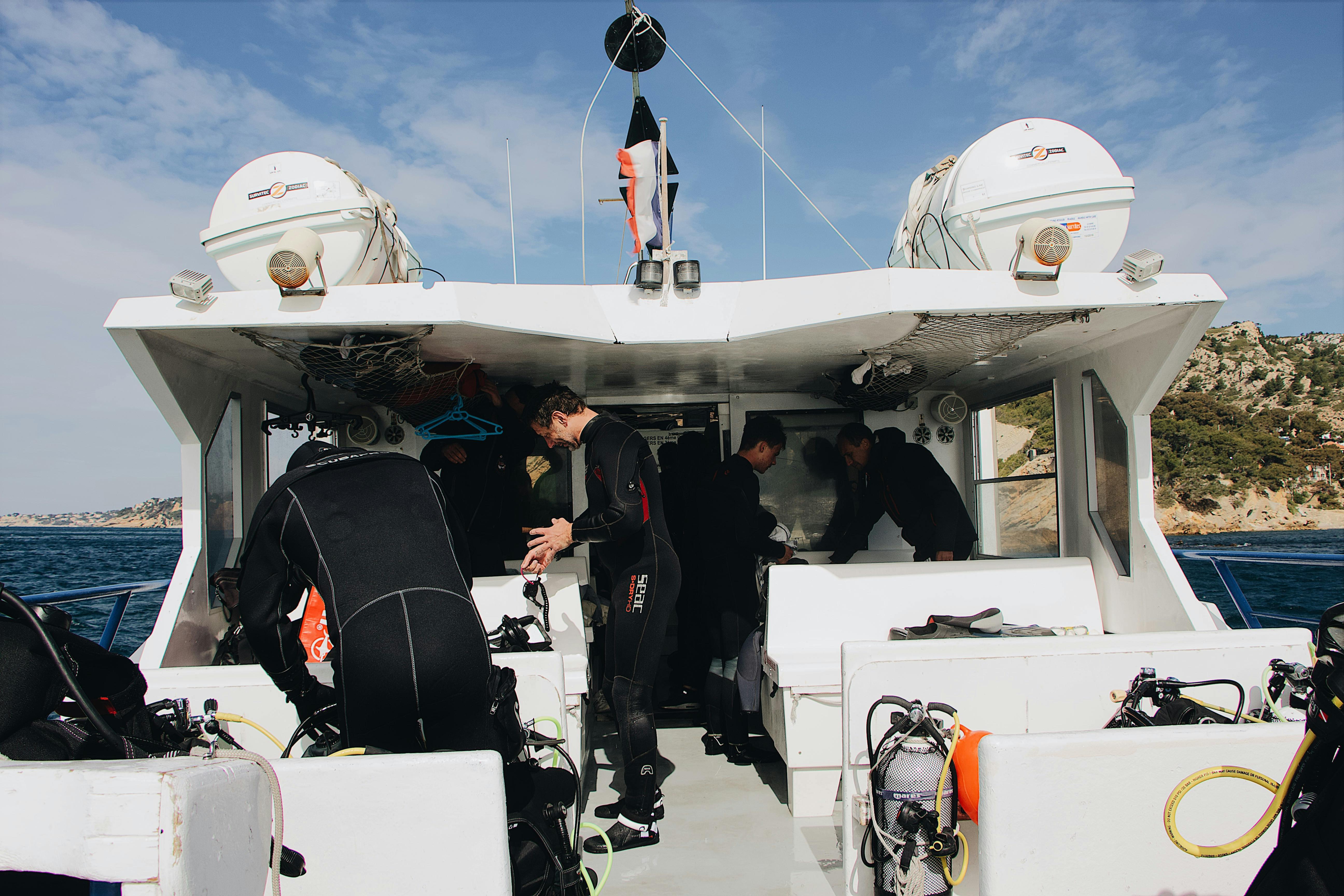 Group of divers preparing their gear on a boat in Lan Ha Bay. - scuba diving north vietnam
