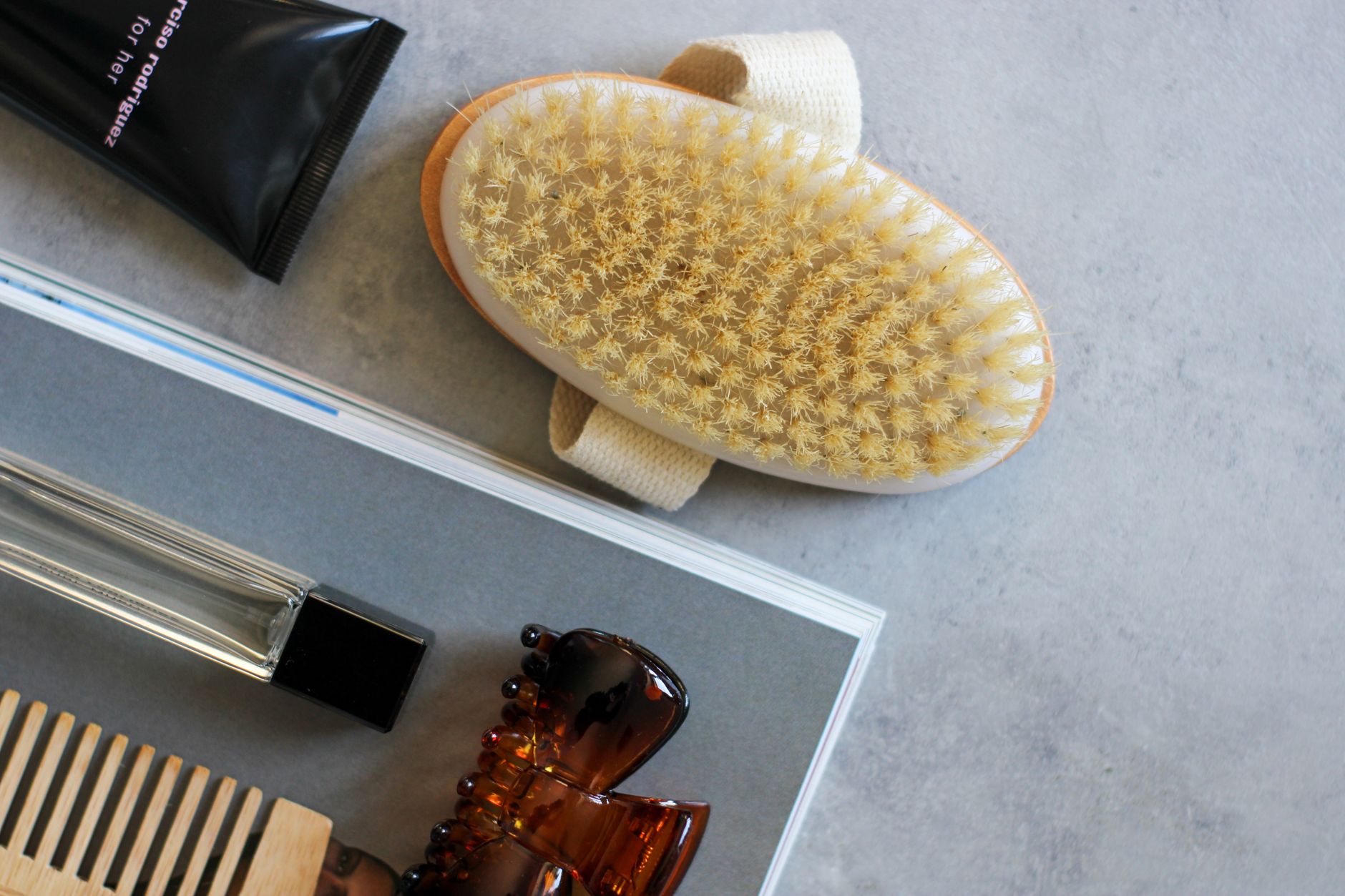 Top 10 Skin Care Hacks For Glowing Skin 1 Flat lay of grooming tools including a hairbrush, comb, and moisturizer.
