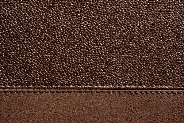 Brown grained leather with a stitched seam — photo by Olga Kovalski on Pexels