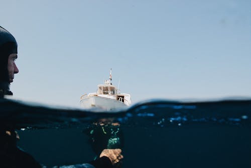  A Yacht On Sea And Man Underwater