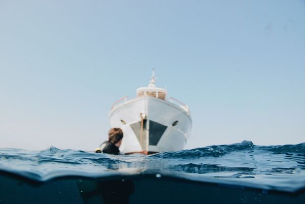 Diver in the water next to the dive boat