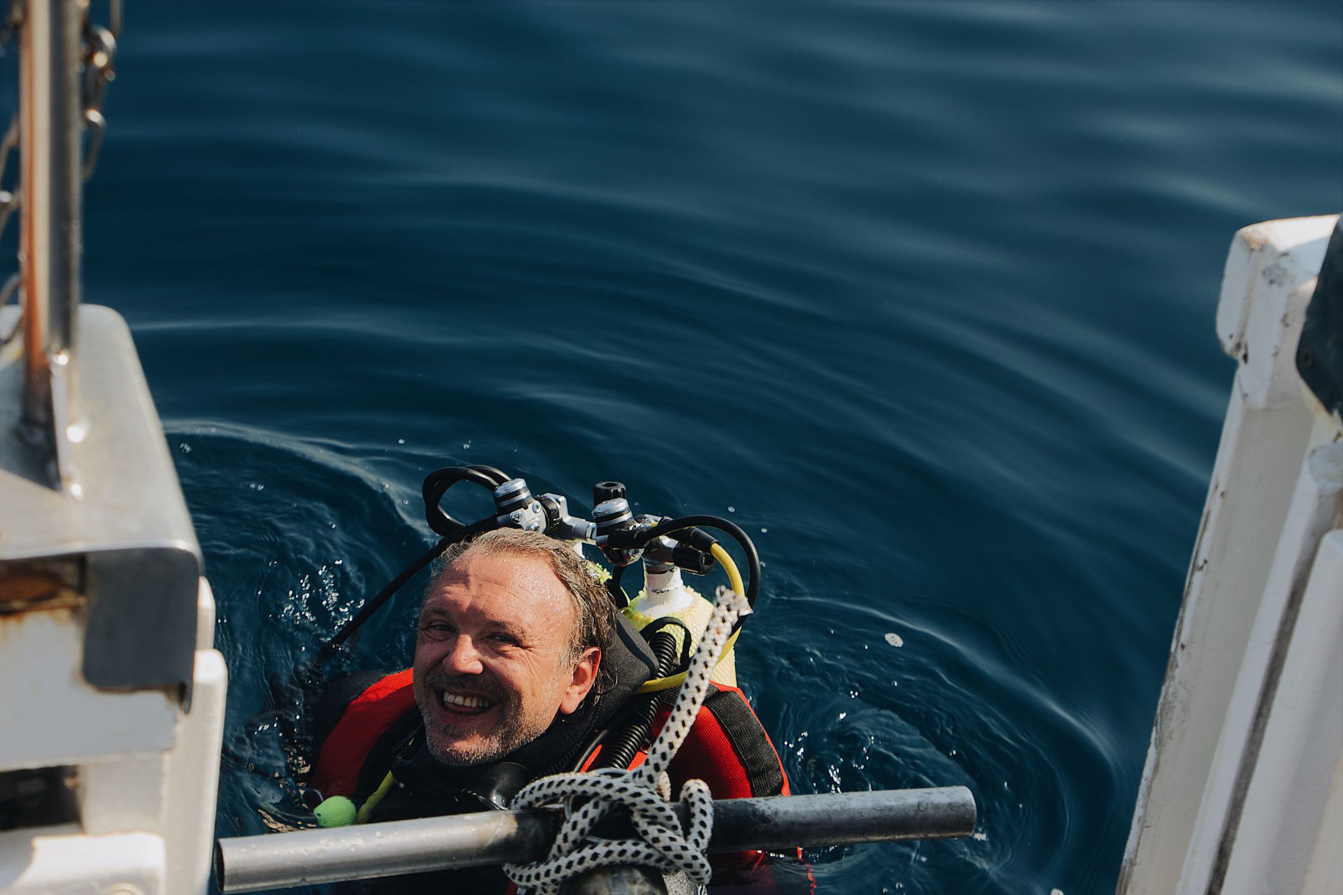 Smiling scuba diver surfacing after a dive