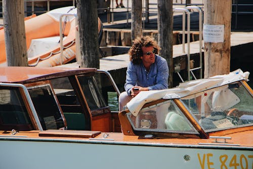 Photo Of Man Sitting On Yacht