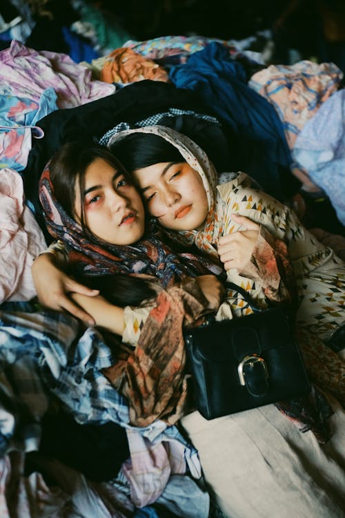 Girls Lying On Some Clothings