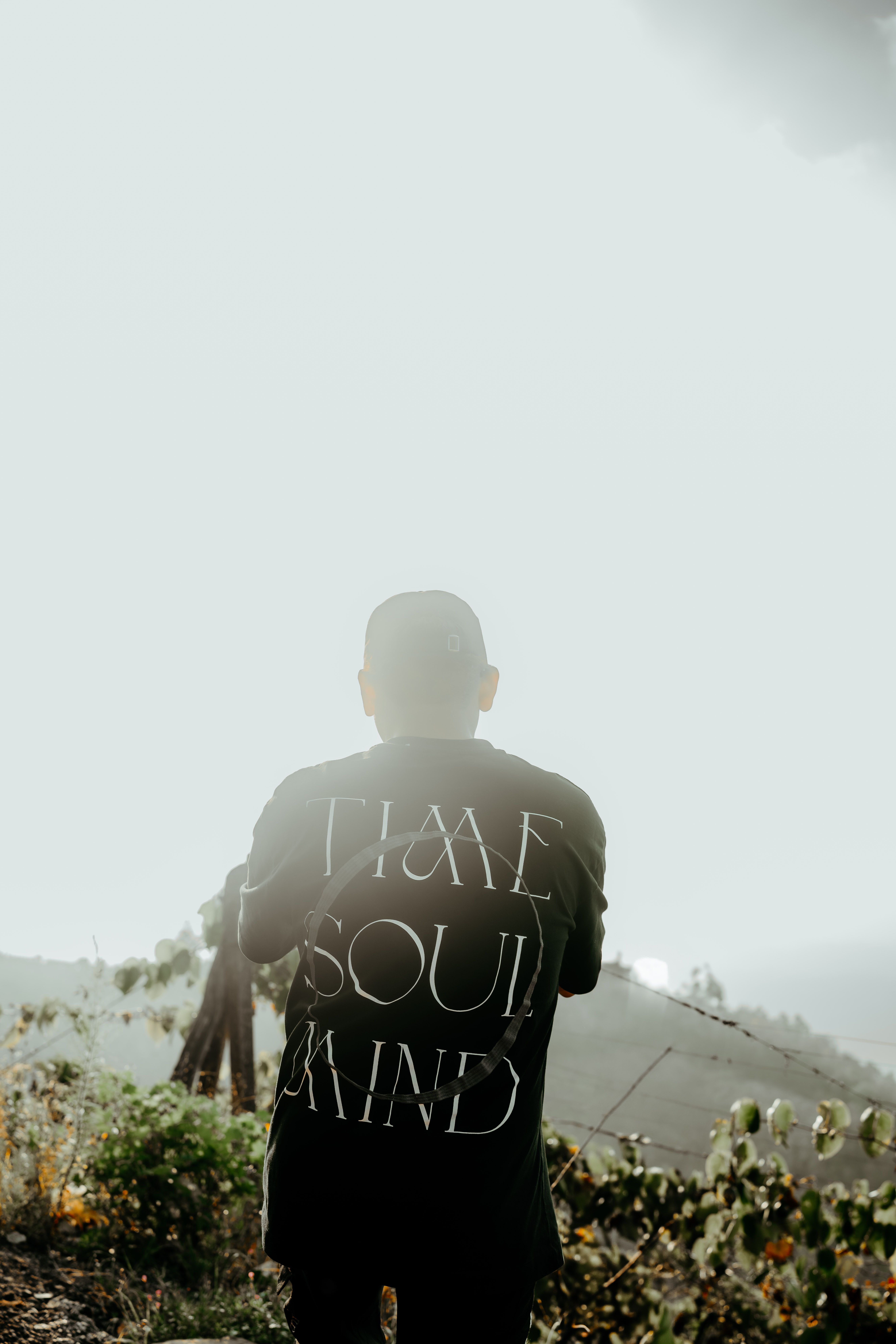 A backlit portrait of a man outdoors in Portoviejo, Ecuador, showcasing a scenic view.
