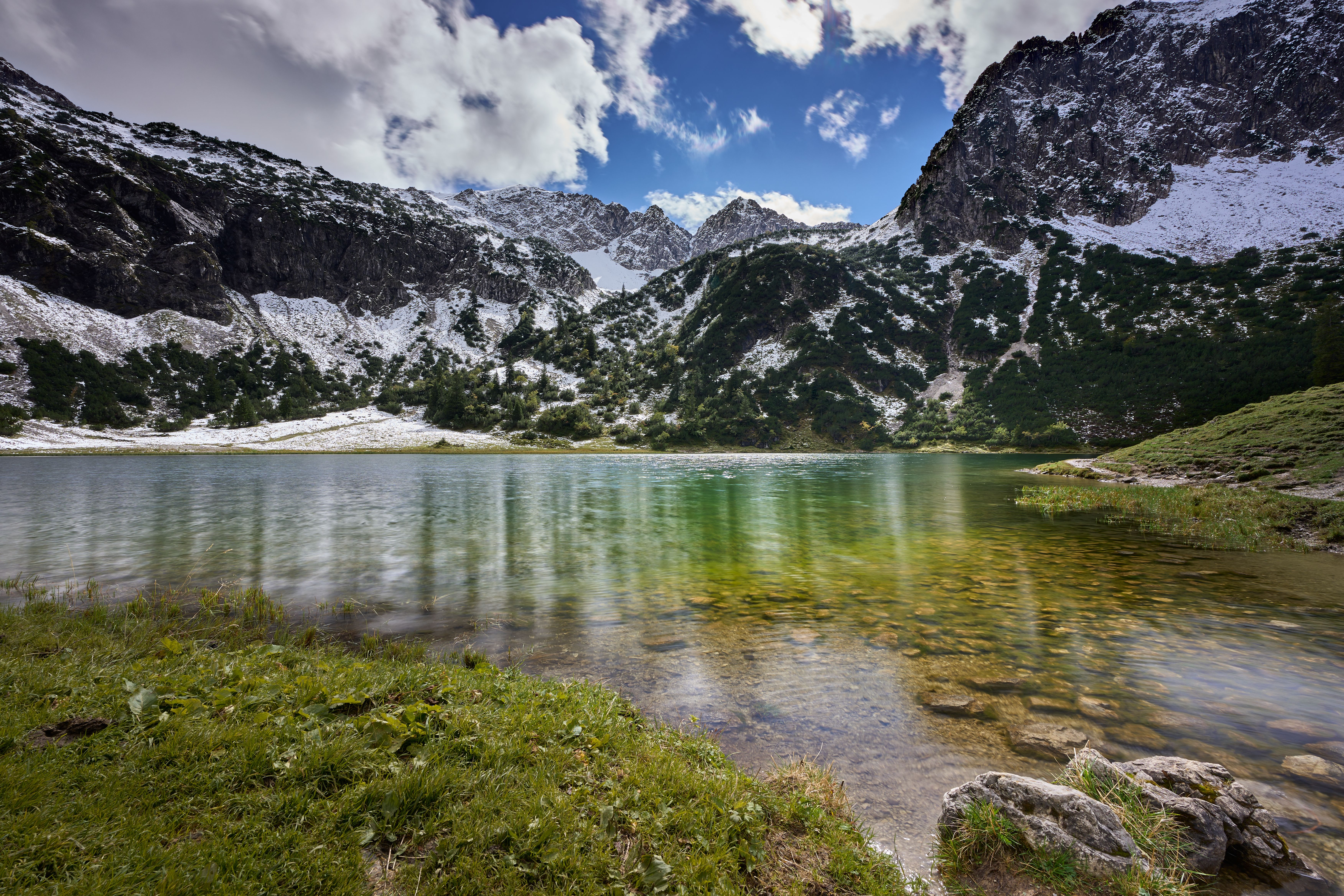 Scenic Alpine Lake with Snow-Capped Mountains · Free Stock Photo