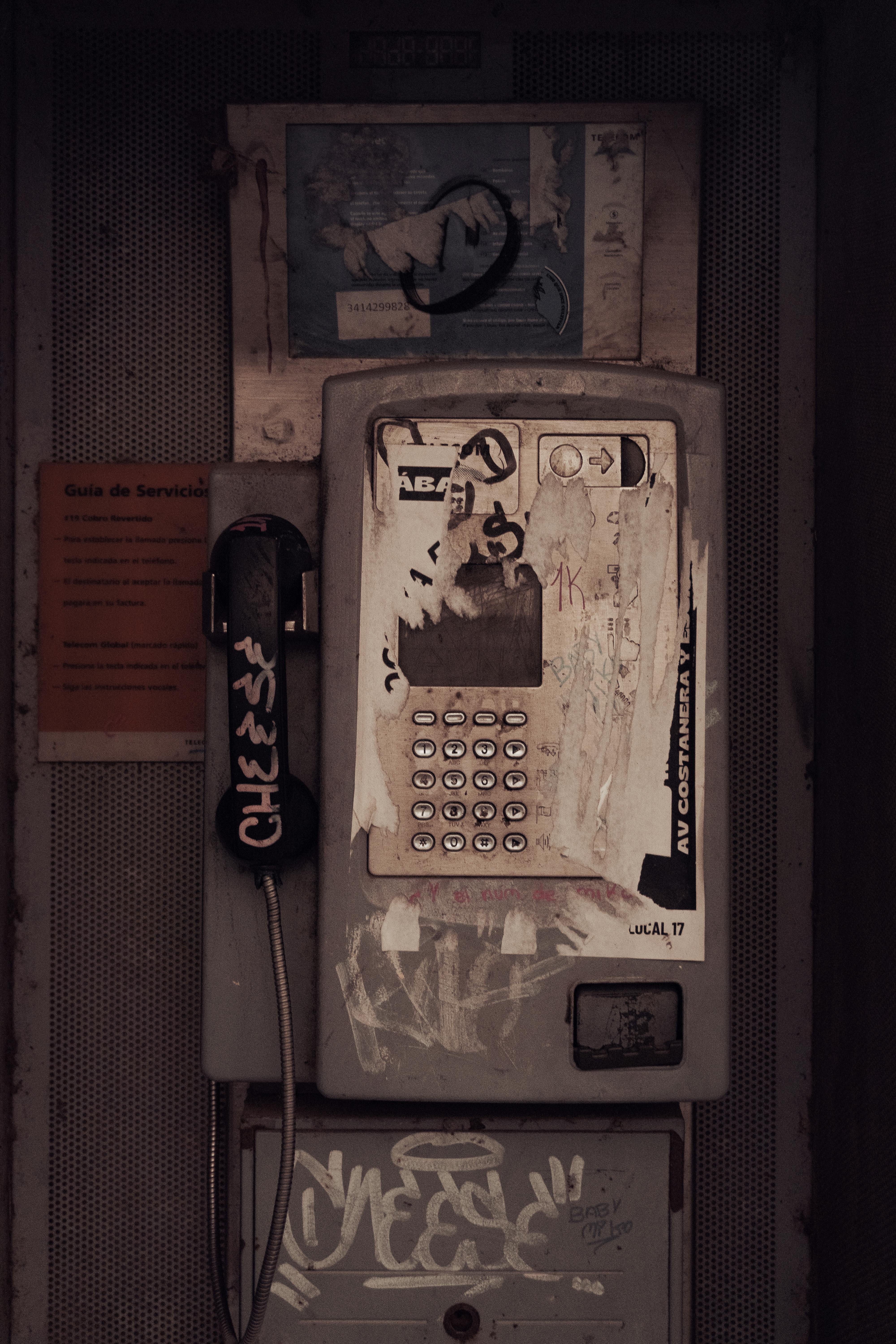 grátis Cabine telefônica antiga coberta de grafites e adesivos, mostrando a decadência urbana em Rosário, Argentina. Foto profissional