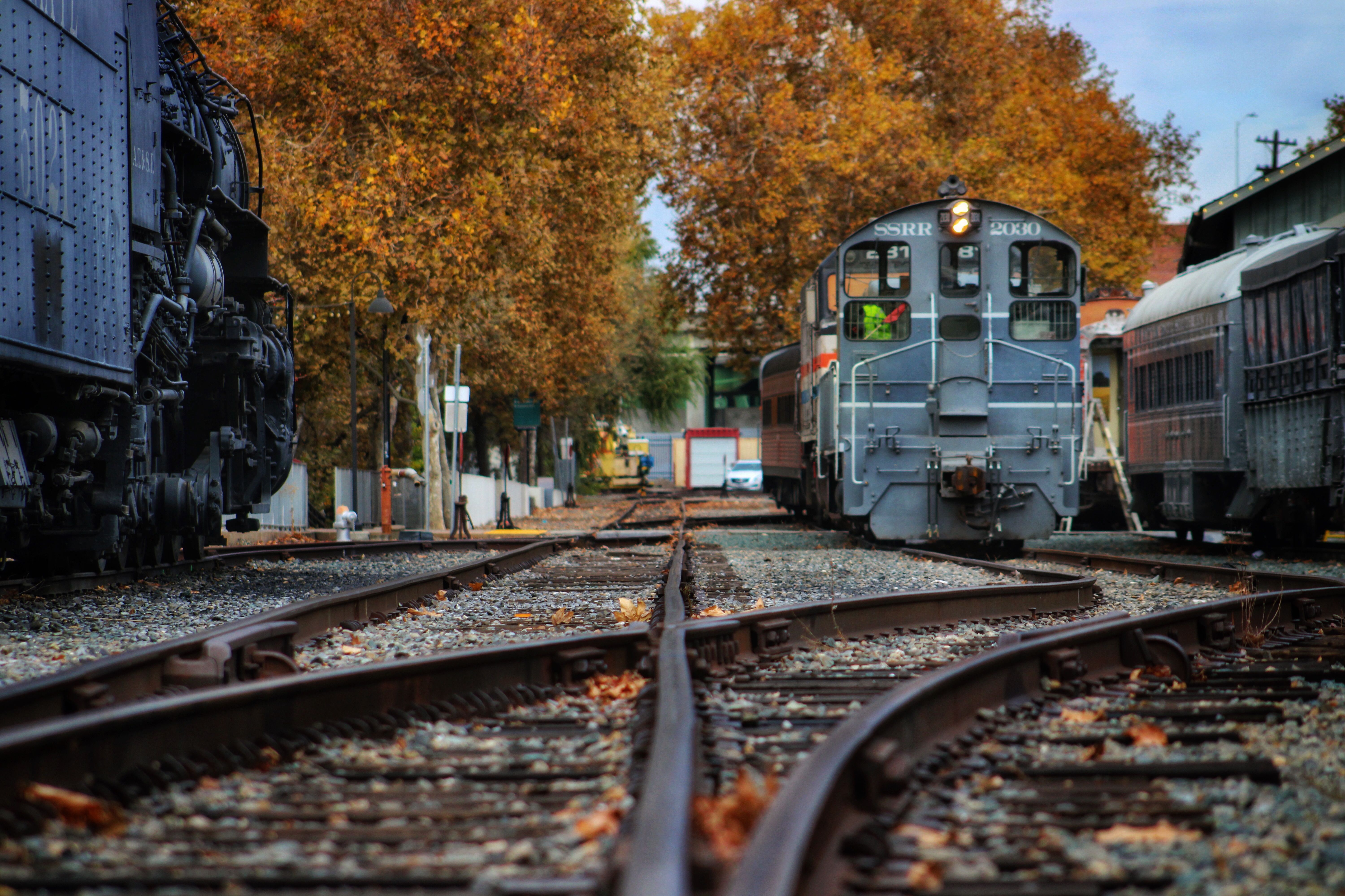 Vintage Train on Tracks with Autumn Foliage · Free Stock Photo