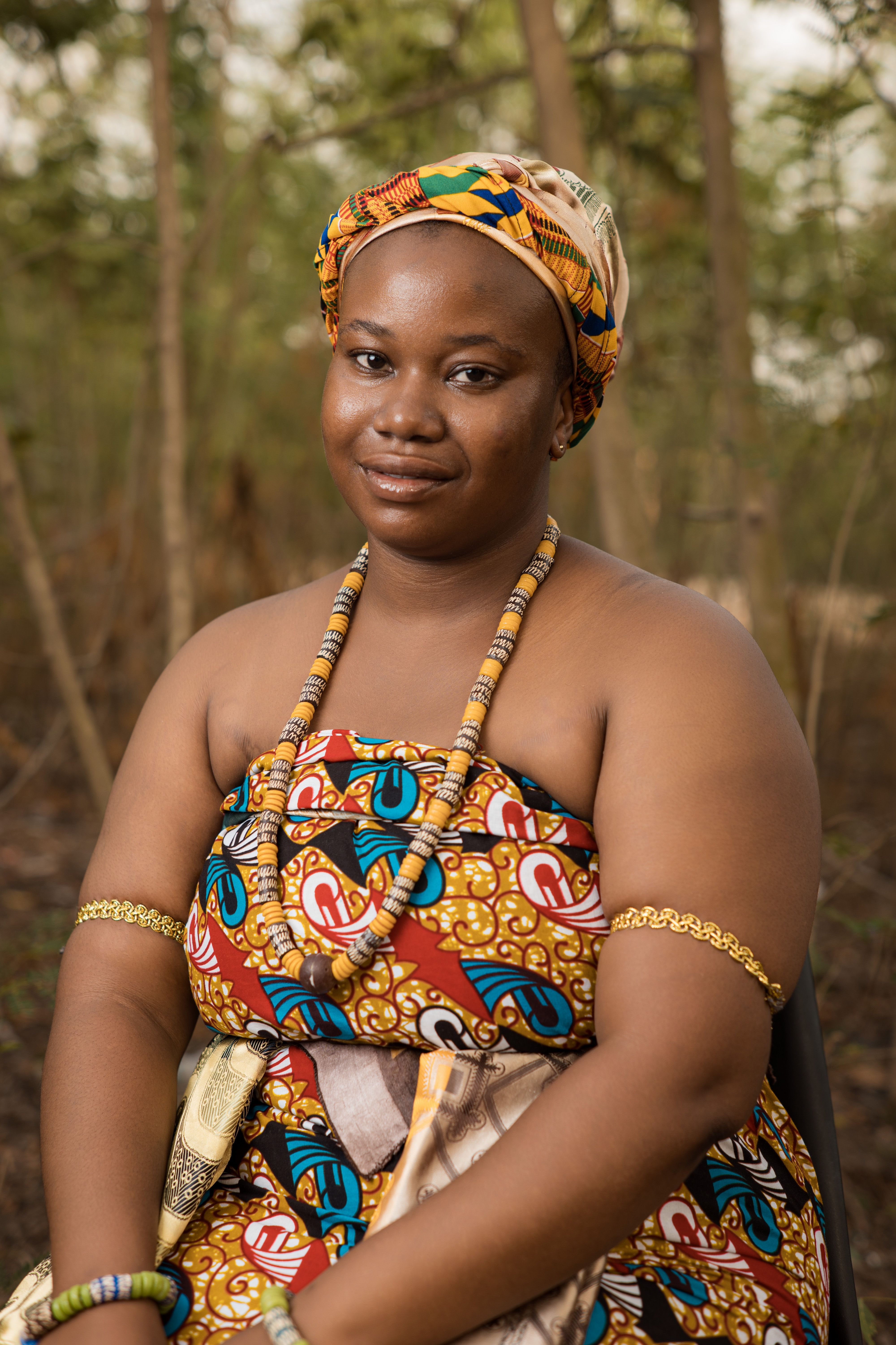 Portrait of a woman in vibrant African attire outdoors · Free Stock Photo