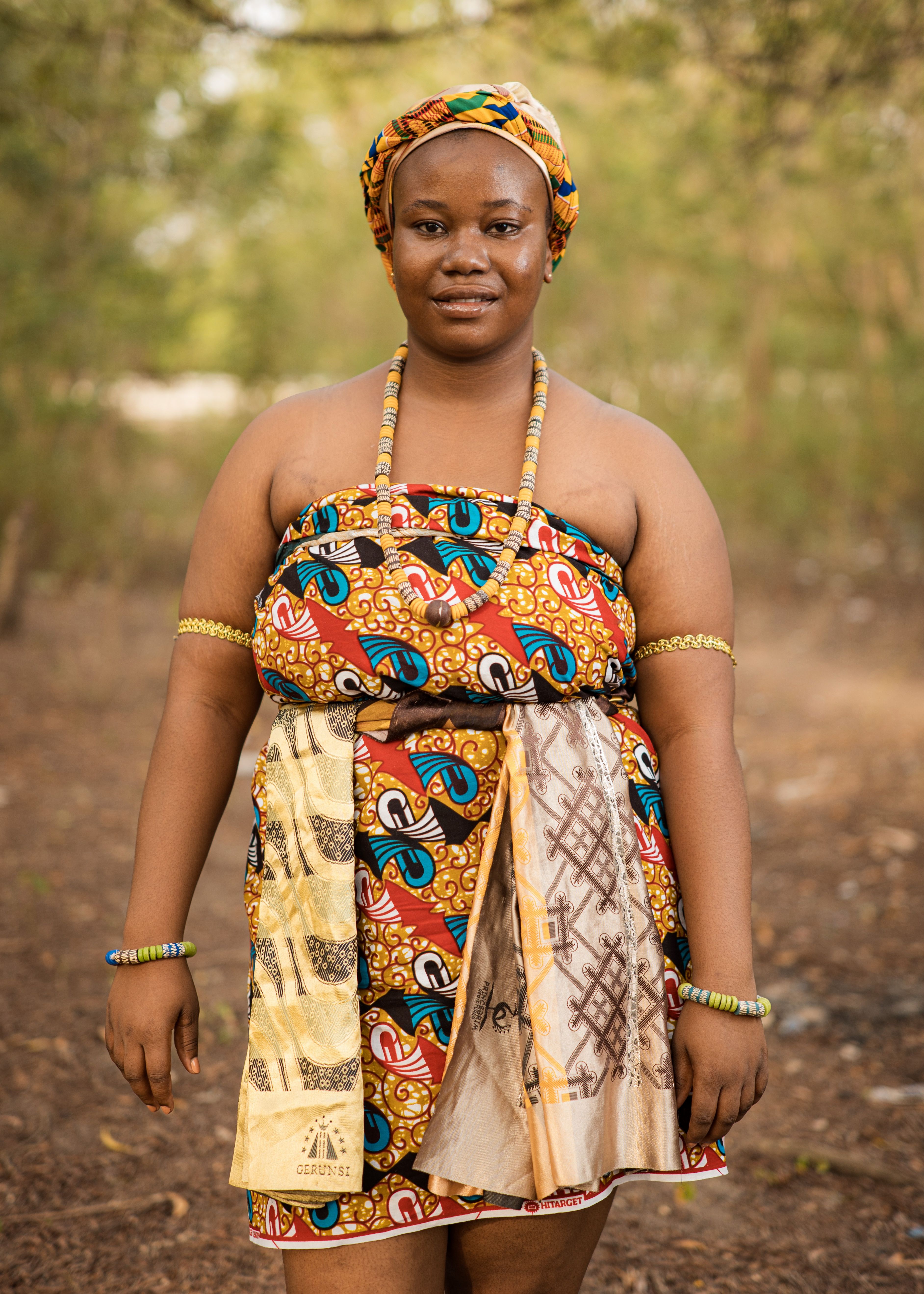 African Woman in Colorful Traditional Outfit Outdoors  Free Stock Photo