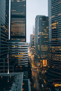 Elevated view of downtown Seattle's illuminated skyscrapers at night, capturing a moody urban atmosphere.
