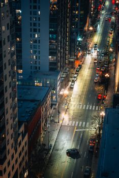 Aerial view of a rainy street in downtown Seattle at night, capturing city lights and wet roads.