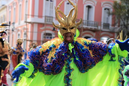 Free A performer in colorful costume and mask at a lively outdoor carnival parade. Stock Photo
