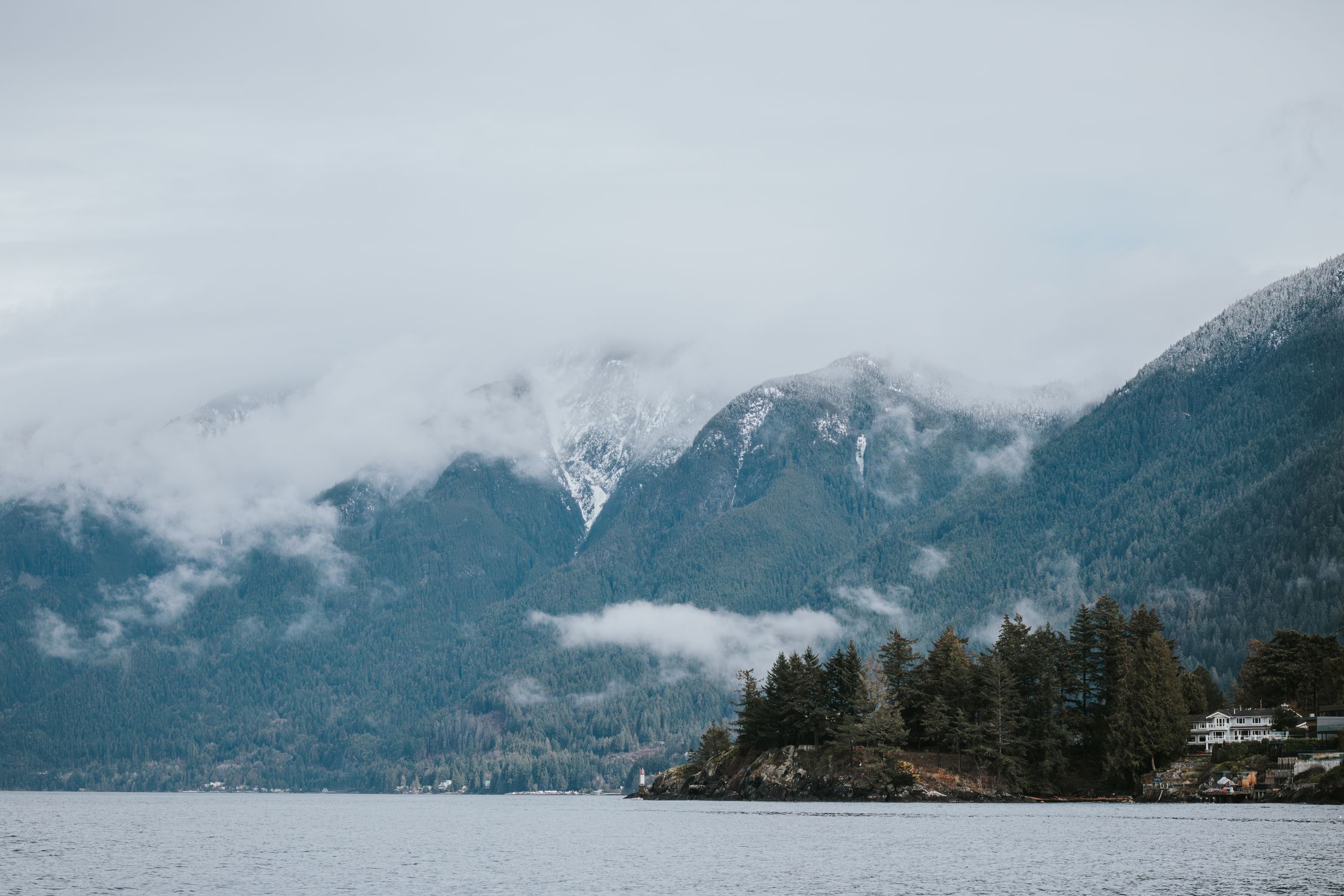 Stephane Hurbe Misty mountain landscape with forested islands in West Vancouver, BC