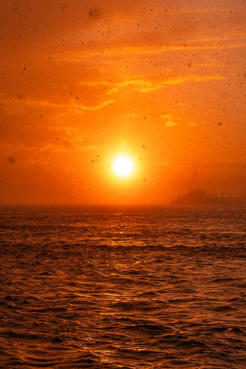 Free A stunning sunset with golden hues reflecting over the ocean waves, evoking a sense of calm and wonder. Stock Photo