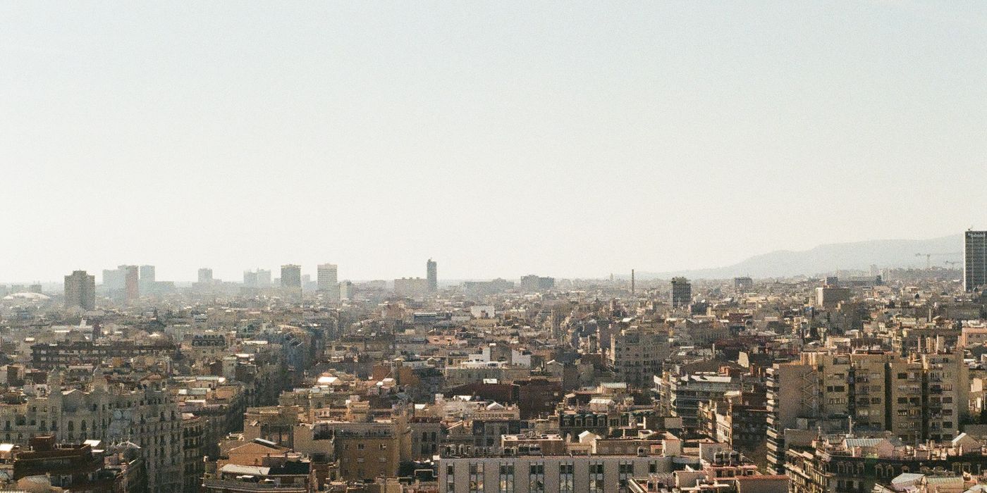 Panoramic view of Barcelona cityscape under blue sky