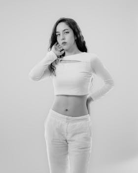 Stylish black and white portrait of a confident woman in a minimal setting.