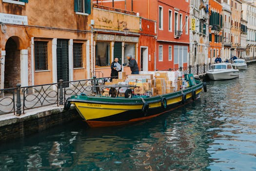 A delivery boat loaded with packages on a canal in Venice, Italy.